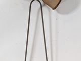 a metal object with a wooden bow on top of it