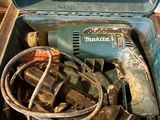 a blue tool box with tools in it sitting on a table