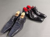 two pairs of shoes sitting on top of a table
