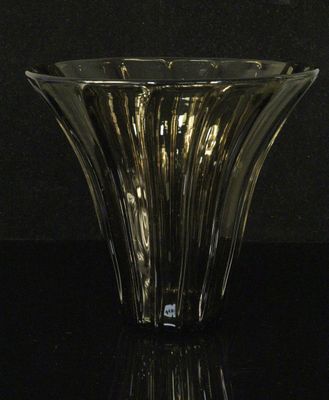 a close up of a glass vase on a black surface