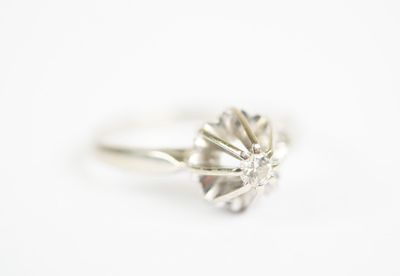an image of a diamond ring on a white surface