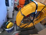 a yellow hose on a cart in a room