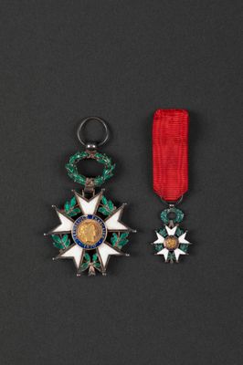 a close up of two medals on a black surface