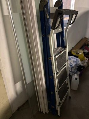 a ladder that is next to a window in a room