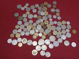 a pile of coins on a red surface