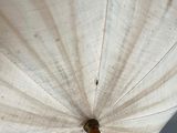 a white umbrella with a gold handle on a pole