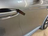 a close up of a car door handle with a sticker on it