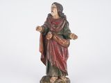 an old statue of a man with a red robe and a red robe