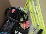 a cardboard box filled with assorted sports equipment