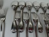 a lot of forks and spoons on the table