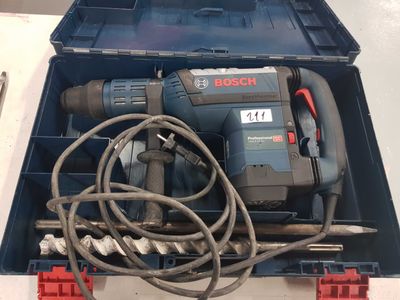 a box with a drill and other tools in it