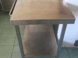 a stainless steel table in a kitchen with a sink