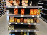 many shelves of food in the store for sale