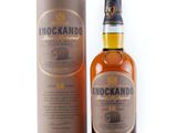 a bottle of knockando whisky next to a cardboard box