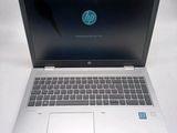hp laptop computer on a white surface with a blue screen