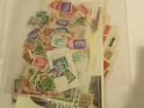 a bag full of postage stamps sitting on a table