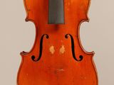 an old violin with a bow hanging from it ' s back