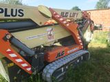 a crane that is sitting in the grass near a building