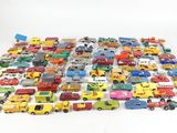 a lot of toy cars and trucks on a white surface