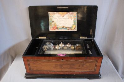 a wooden box that has a musical box inside of it