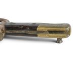 a small metal object with a handle on a white surface
