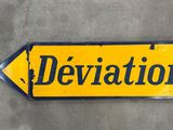 a yellow and black sign with the word deviation written on it