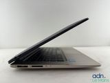 the back of a laptop computer sitting on top of a white table