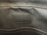 a close up of a black bag with a leather label on it