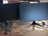 three computer monitors sitting on top of a wooden table