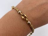 a close up of a person ' s arm wearing a gold bracelet