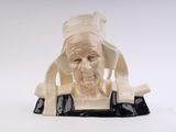 a figurine of an old man sitting on a table