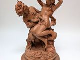 statue of a woman and a man sitting on a rock