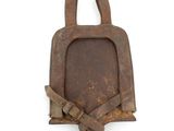 an old rusty piece of iron hanging on the wall
