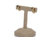pair of gold and blue stone stud earrings on a burlocked stand