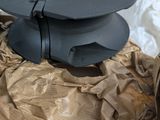 a black spool sitting on top of a piece of paper