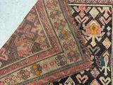 an image of a close up of a rug on a white surface