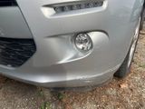 a close up of a car ' s front bumper and headlight