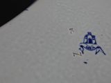 a blue and white plate with a picture of a horse on it