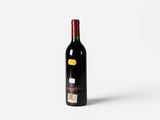 a bottle of wine sitting on top of a white surface
