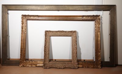 two frames that are sitting on the floor next to each other