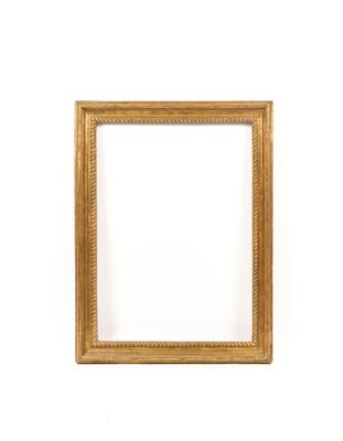 a gold picture frame on a white wall with a white background
