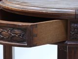 a close up of a wooden table with a drawer in it