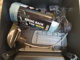 a box with a drill and other tools inside of it