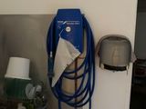 un tuyau bleu accroché au mur à côté d'un évier