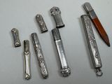 five different types of pens and a pencil on a table