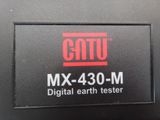 a close up of a digital earth tester on a table