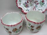 two cups and a saucer sitting on a table