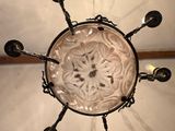 a chandelier made of glass with a circular design on it