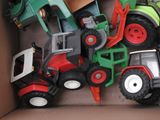 a box full of toy tractors and trucks in it
