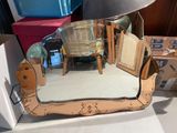 a mirror that is sitting on a table next to a lamp